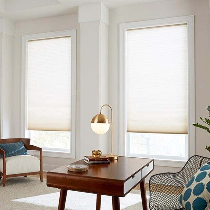 Light filtering cellular shades in color white.