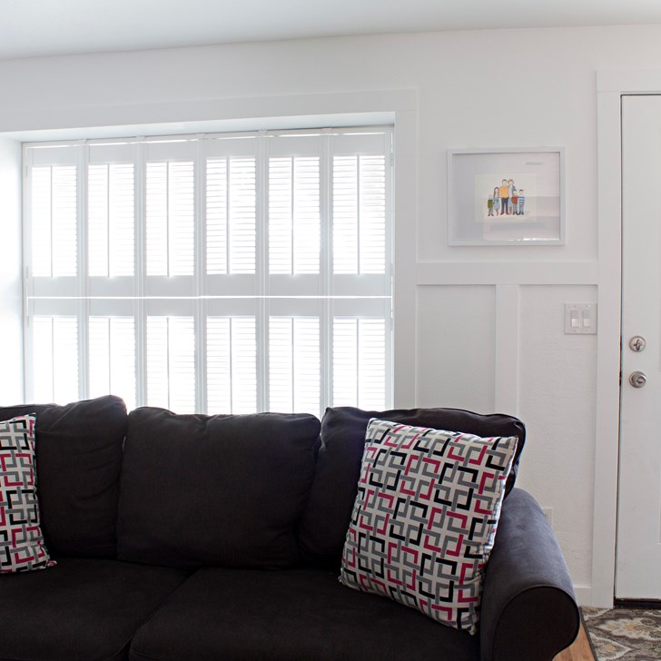 Customer Tiffany from Making the World Cuter gave her living room a charming vintage feel with double hung Simplicity Cottage Wood Shutters.