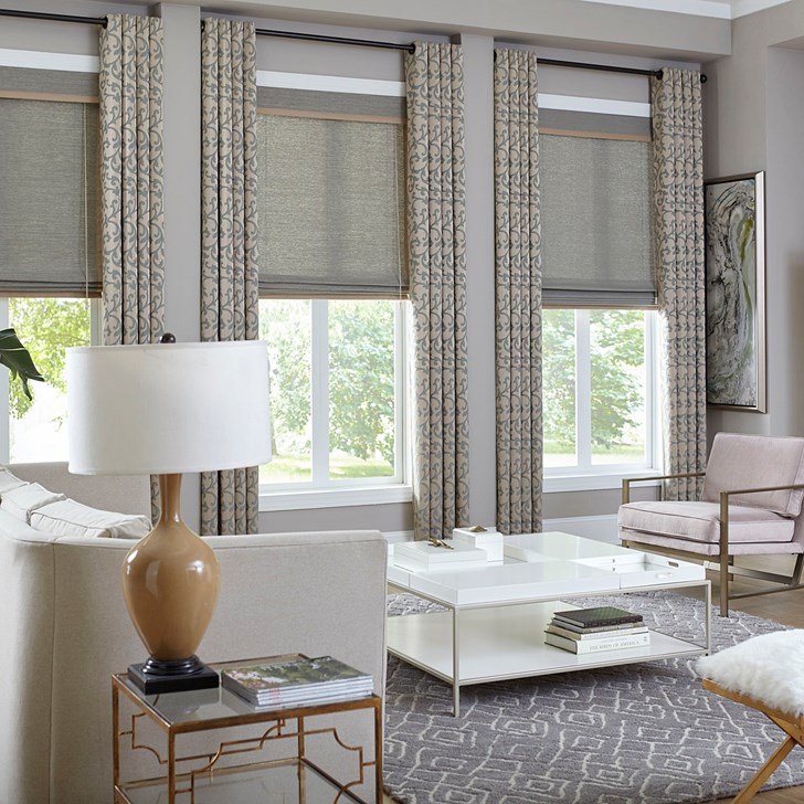 The deluxe woven wood shade paired with the easy grommet drapery. Woven Shade Color: Capri Pewter 9450 (discontinued) & Drapery Color: Belize Caribbean