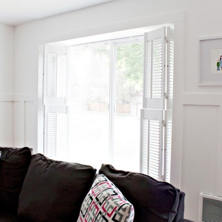 Customer Tiffany from Making the World Cuter gave her living room a charming vintage feel with double hung Simplicity Cottage Wood Shutters.
