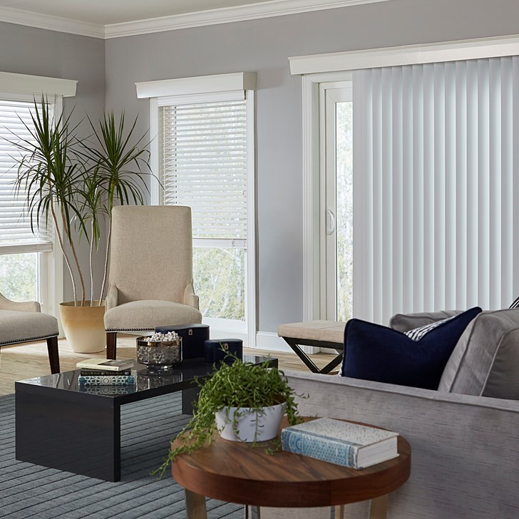 Vinyl Vertical Blinds in the Basic Smooth White color, 2 Inch Wood Blinds in the White color, and the Wood Cornice in the Davenport Cotton color.