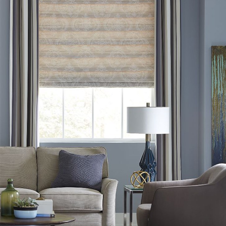 Premier Grommet Drapery Panel shown in the pattern Canyon, and it is layered over our Premier Roman Shade in Vittoria Barley.