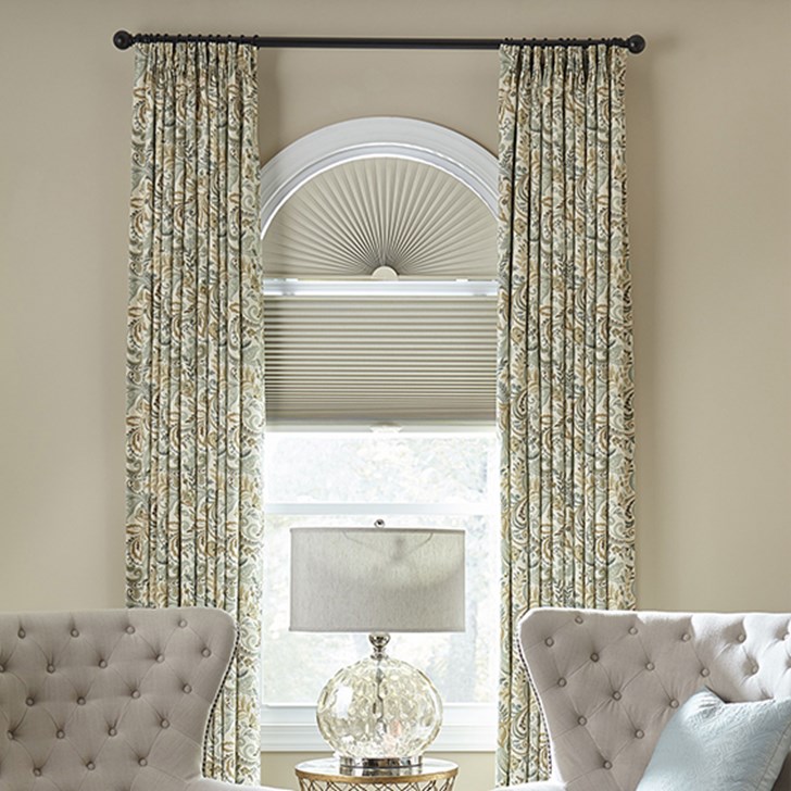 The blackout cellular shade paired with the blackout cellular arch and the easy classic pleat drapery. Shade Color: Early Light SBB702; Drapery Color: Venice