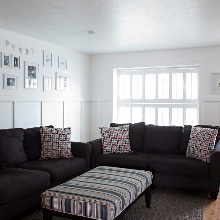 Customer Tiffany from Making the World Cuter gave her living room a charming vintage feel with double hung Simplicity Cottage Wood Shutters.